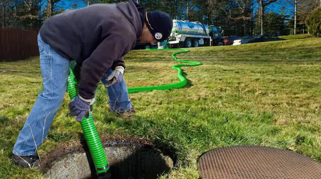 Service technician performing residential septic pumping and drainage maintenance in Charlotte, NC